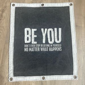 Super cute wall hanging with grommets.